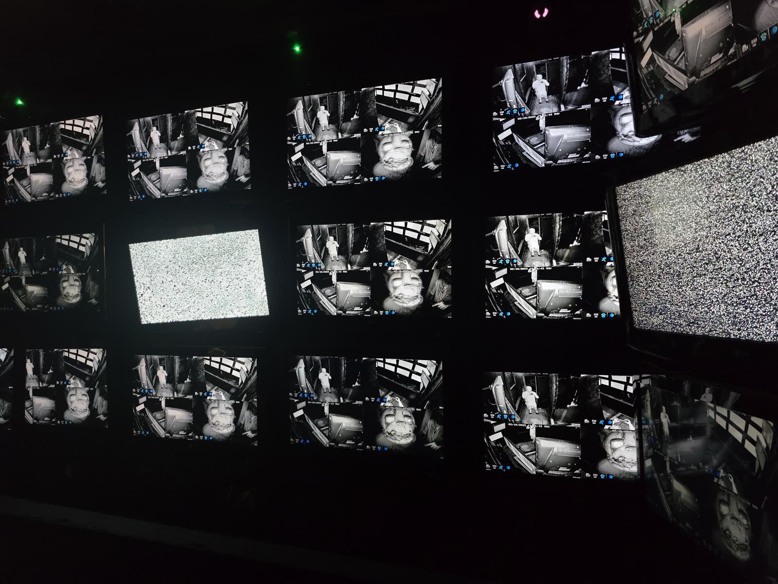 A dark control room filled with surveillance monitors inside the attraction.